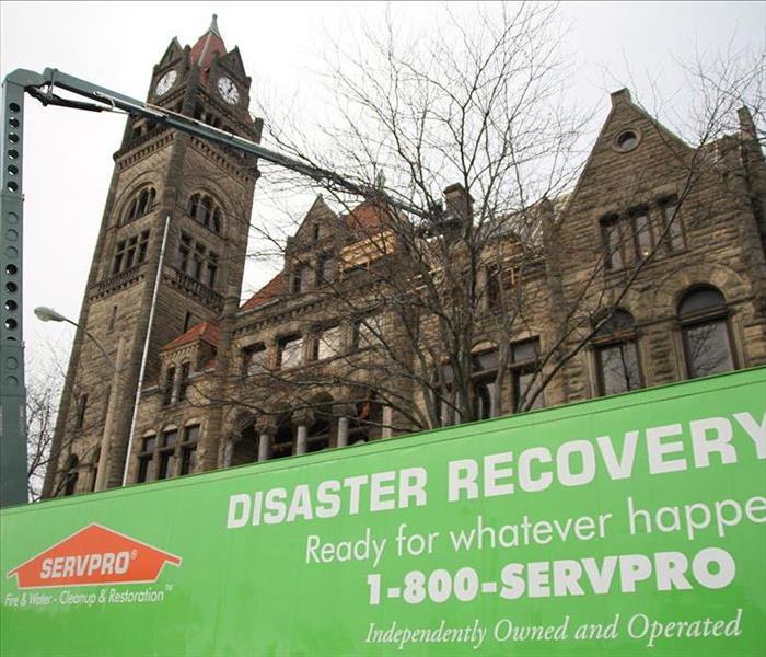 SERVPRO vehicles in front of historic building with storm damage